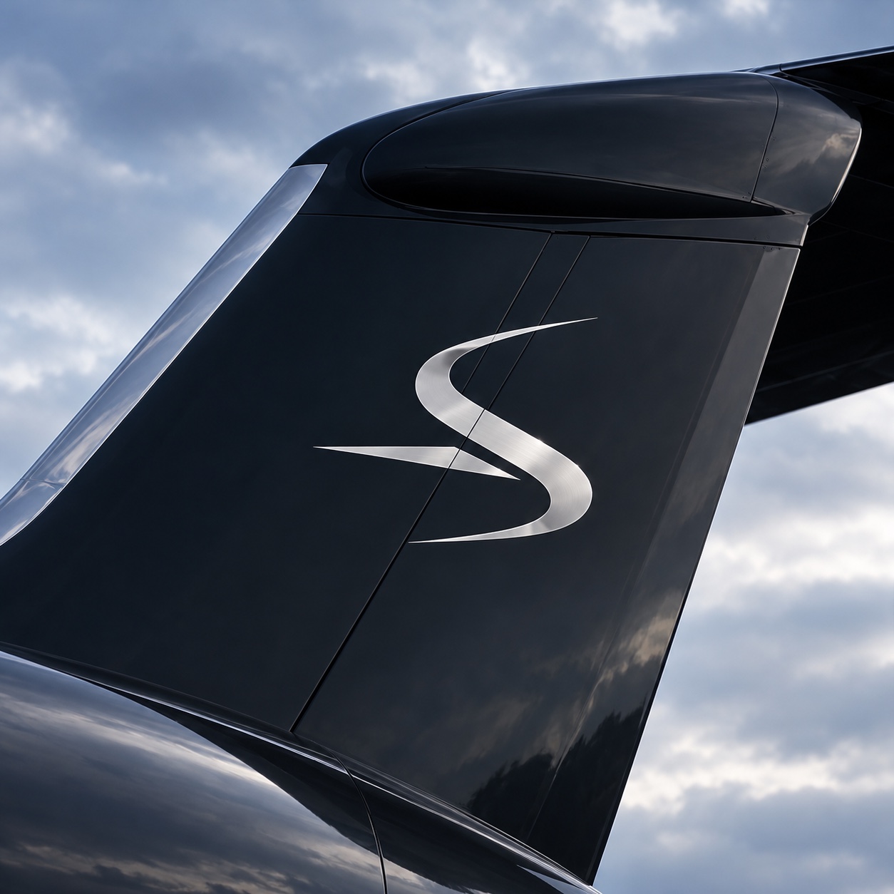 Illustrative midnight jet tail with Soravia’s silver emblem